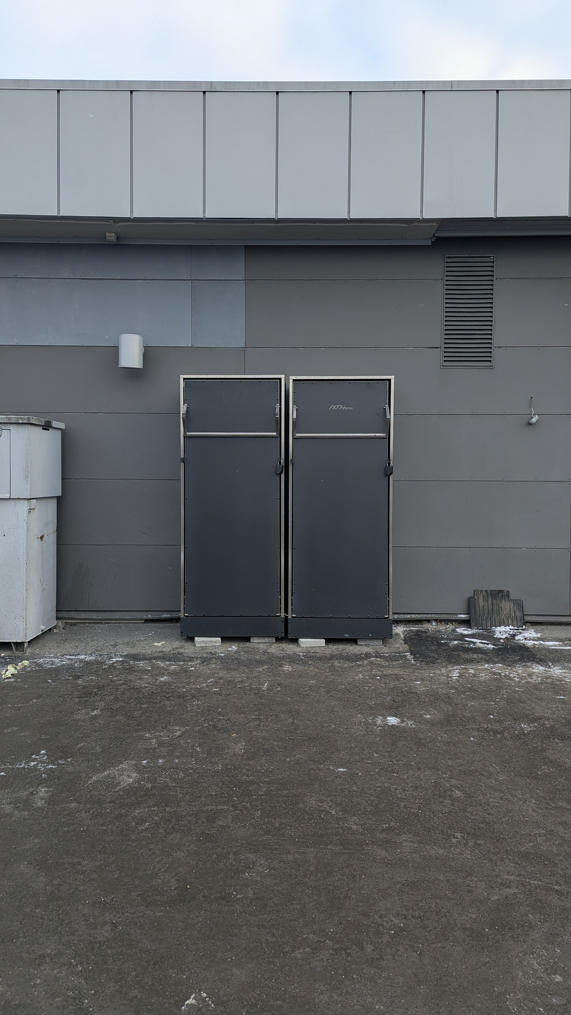 The production wardrobe stand installed on a forecourt, both doors closed