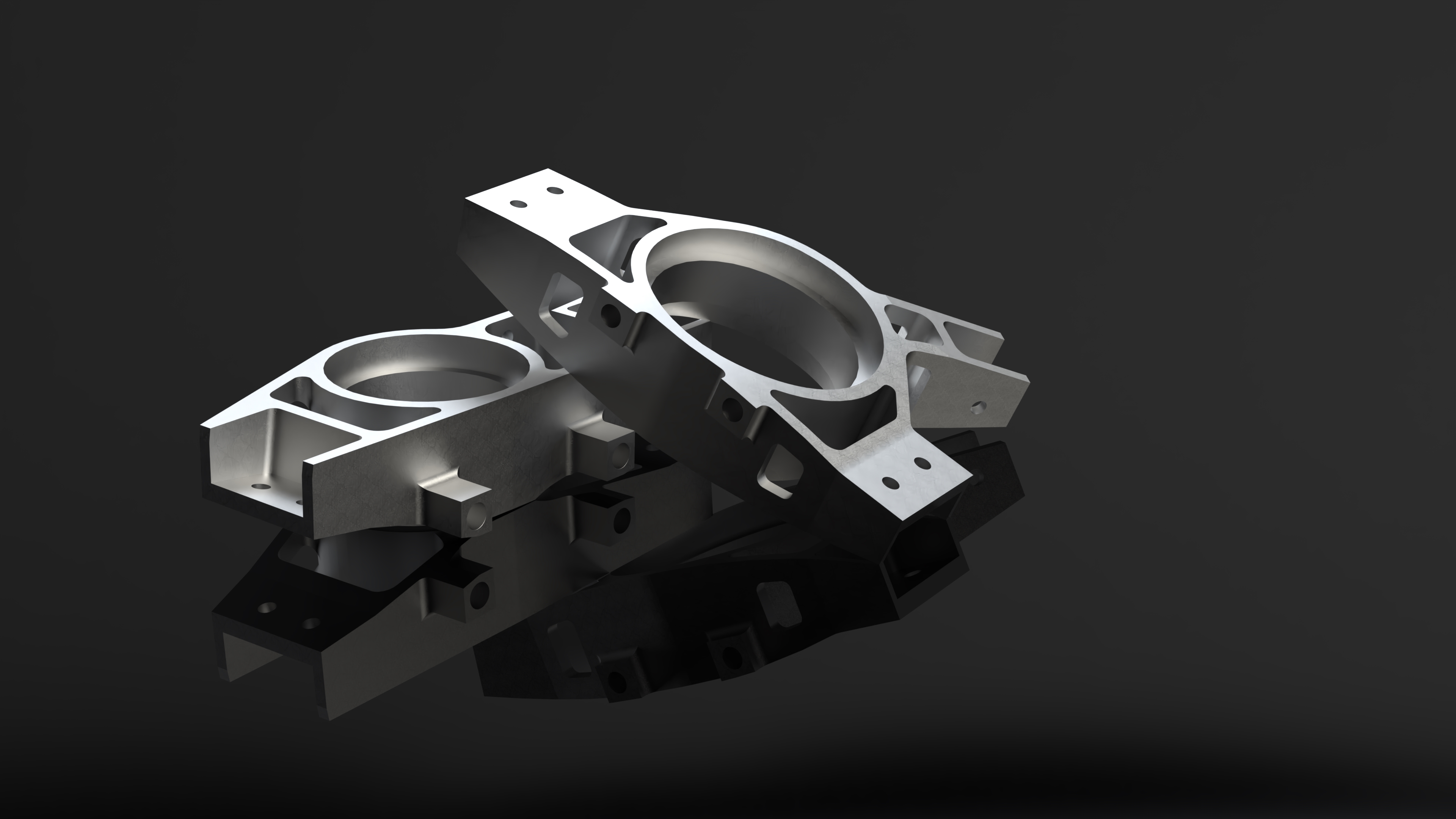 Render of two machined aluminium suspension uprights on a dark reflective surface